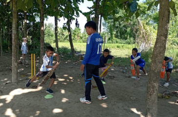 Children playing cricket in the village