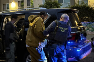 Nakahli Miller being prepared for transport after his arrest